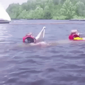 A gif of two kids paddling a sinking canoe