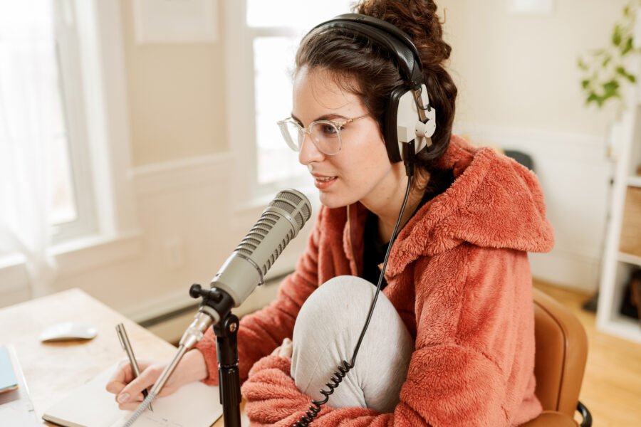 Woman podcasting from her home office